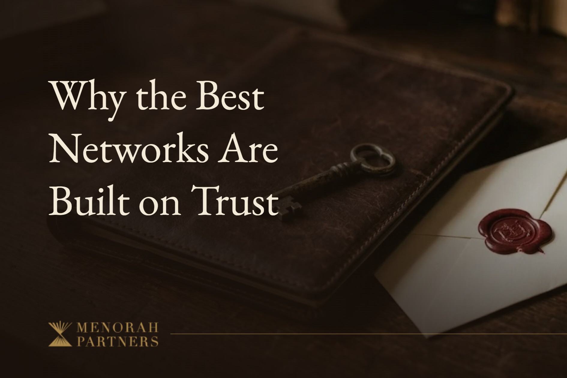 A brass key resting on a closed leather portfolio beside a wax-sealed envelope on a dark wooden desk, with the title “Why the Best Networks Are Built on Trust” and the Menorah Partners logo